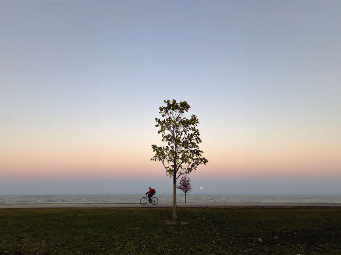 Person On Bike By Shore Of Lake