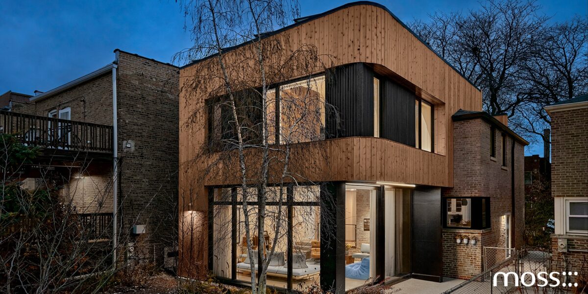 Moss Chicago Architect Home Renovation curved cedar siding rear addition on a brick home with a landscaped back yard, birch trees